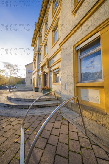 Historic building with entrance area, warm sunlight on paved courtyard, Aidlingen, Böblingen