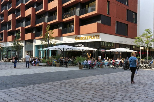 Street café with lettering Überseeplatz, passers-by, Westfield Überseequartier, modern shopping