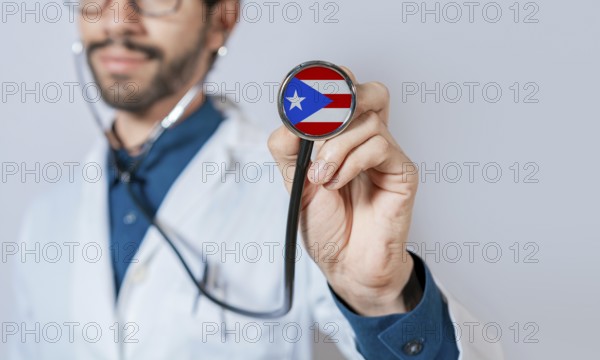 Doctor holding stethoscope with Puerto Rico flag. Puerto Rico health and care concept. Puerto Rico