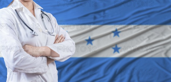 Doctor with crossed arms on Honduras flag. Honduras health and care concept. Female doctor on