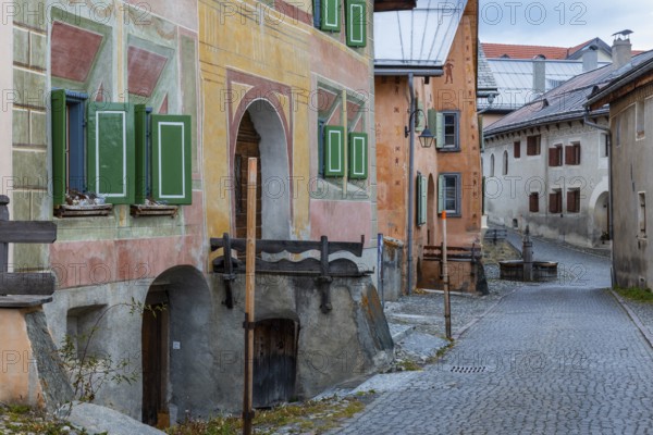 Engadin houses, historic houses, Dorstrasse with stones, village fountain, Guarda, Engadin,