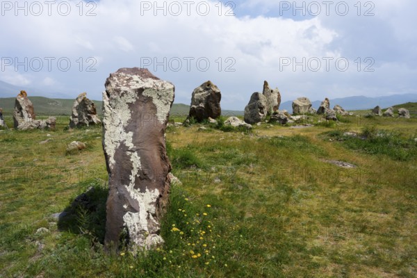 Stone pillars in a natural meadow under a blue sky, stone circle, megaliths, Zorats Karer,