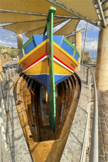 Monument to traditional fishing boats abandoned jacked up typical colorful painted old fishing boat
