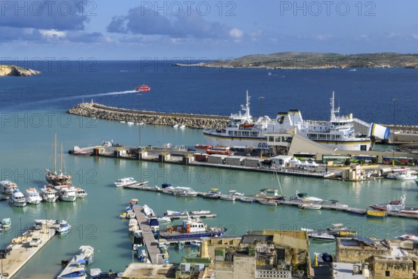 View from an elevated position of Mgarr harbour on the island of Gozo, large car ferry with open