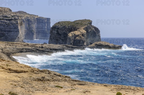 Rough rough sea surf during autumn storm high rugged cliffs burn on beach coast on the