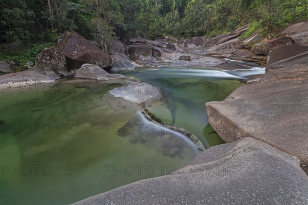 Turquoise blue water between rocks in the tropical rainforest of Babinda Boulders Queensland