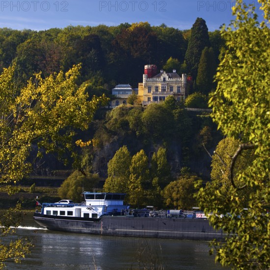 Marienfels Castle with cargo ship on the Rhine River, former residence of entertainer Thomas
