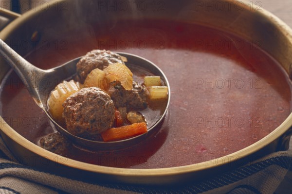 Romanian soup with meatballs, vegetable soup with meatballs, in a pot, homemade, no people
