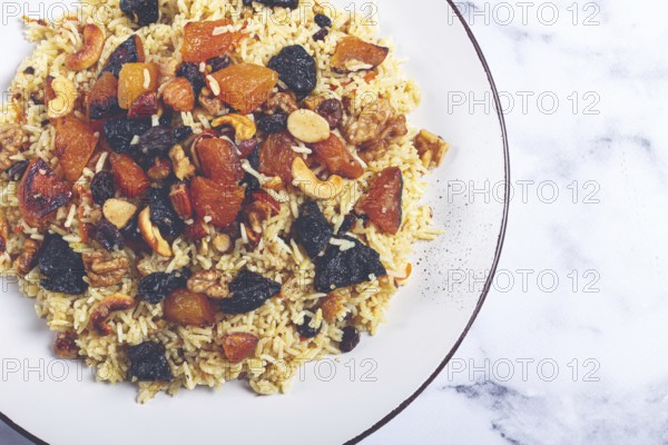 Rice dish, with the addition of dried fruits, nuts and spices of Middle Eastern cuisine, homemade,