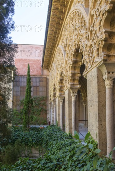 Ornate Islamic design decorated Moorish arches, courtyard garden of Santa Isabel, Aljafería Palace,