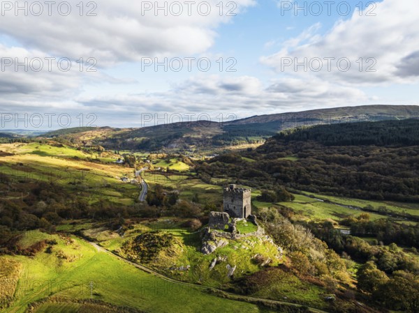 Autumn colours over Castell Dolwyddelan and Eryri Mountains from a drone, Snowdonia, Conwy County