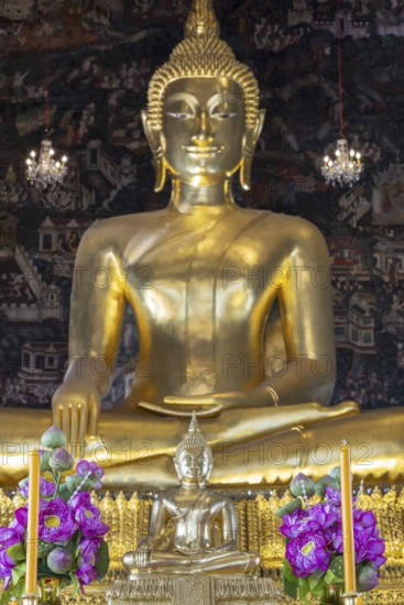 Golden Buddha statue, Phra Buddha Trilokachet surrounded by crystal chandeliers and exquisite wall