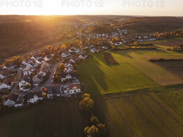 Wide view of a village on a sunny autumn evening with fields and hills, Deufringen, Aidlingen,