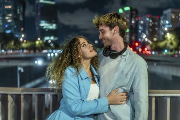 Young couple embracing and looking into each other's eyes, expressing love and togetherness on a