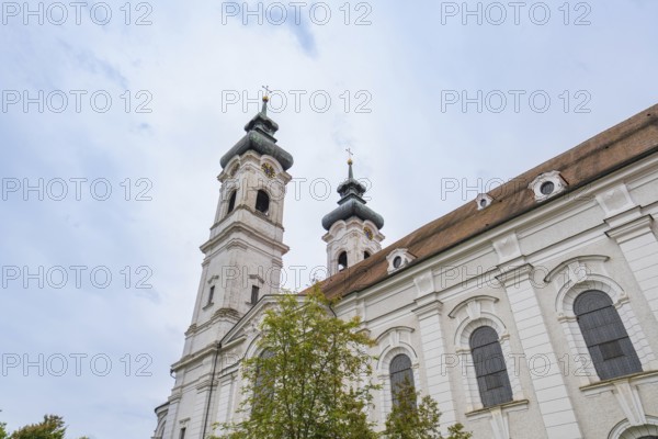 Baroque church with two towers and richly decorated exterior façade under cloudy sky, ZFP