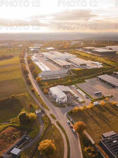 Roads lead through an industrial park with isolated buildings and adjacent fields, DPD, Nagold,