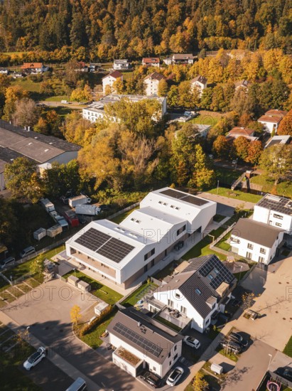 Residential area with modern buildings and solar panels, surrounded by autumnal nature, Nagold,