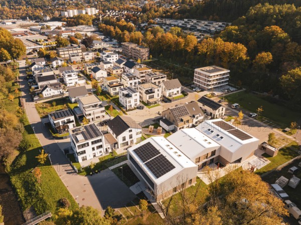 A residential area with modern houses and solar panels, surrounded by autumn trees, Nagold, Black