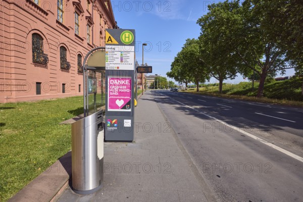 Landtag bus stop, New Armoury, historic building, public trash can, lantern, trees, lawn, blue sky,