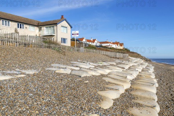 For Sale estate agent signs outside houses at risk of coastal erosion, Thorpeness, Suffolk, North