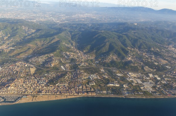 Oblique aerial view of settlements on coastal plain and hillsides, Mediterranean Sea coast, El