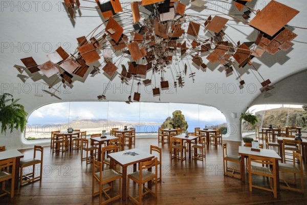 Interior of café with panoramic window in building designed by Cesar Manrique with the