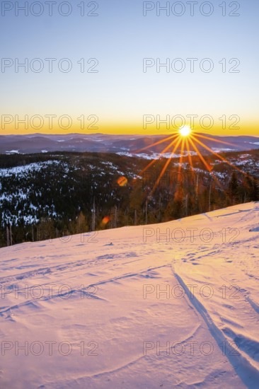 Sunrise over the hills of czech republic from Mount Lusen wth the view over the hills of the