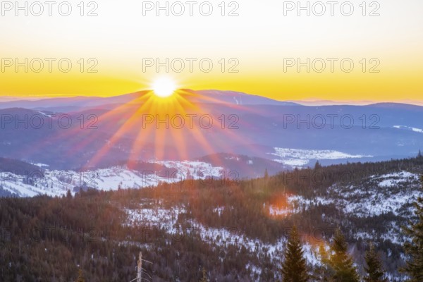 Sunrise over the hills of czech republic from Mount Lusen wth the view over the hills of the