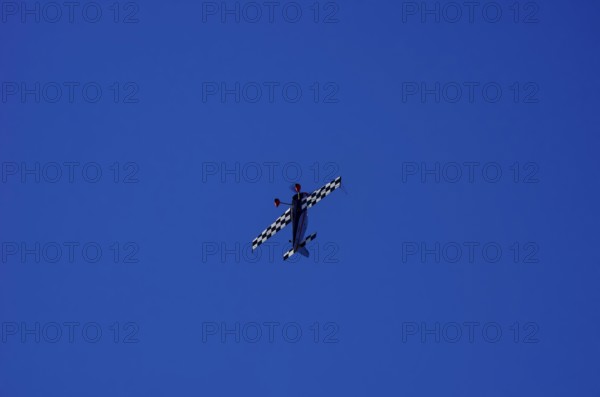 A single-engine aerobatic aircraft during a flight demonstration at the Rossfeld Luftsportverein in