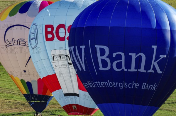 Hot air balloons are being prepared for takeoff as part of an air show at the Fliegerbergfest of