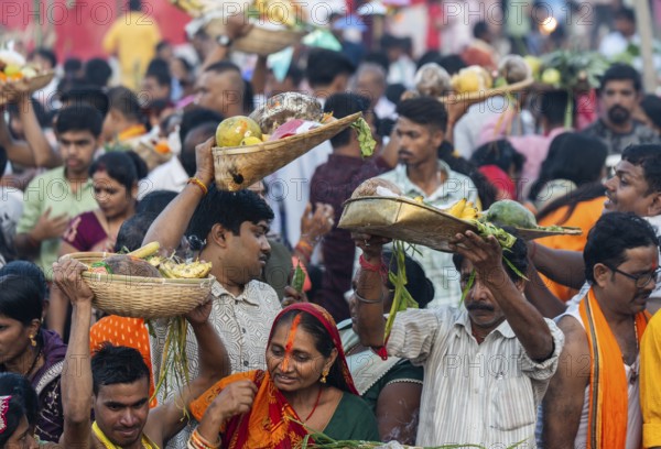 Hindu devotees gather on the banks of the Brahmaputra River to offer prayers to the Sun God on the