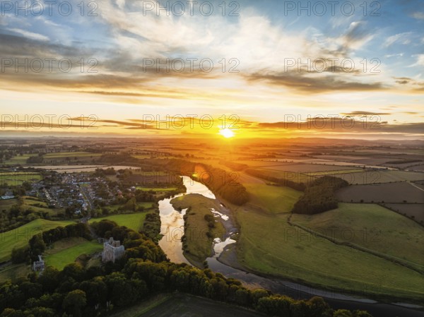 Sunset over Norham Castle and River Tweed from a drone, Norham, Northumberland, England, United