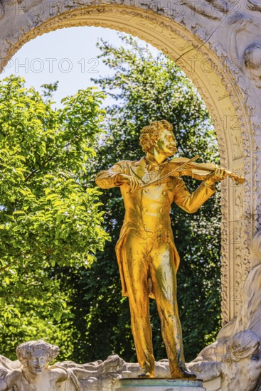 The gilded bronze statue of Johann Strauss, the Waltz King, memorial in the municipal park, Vienna,