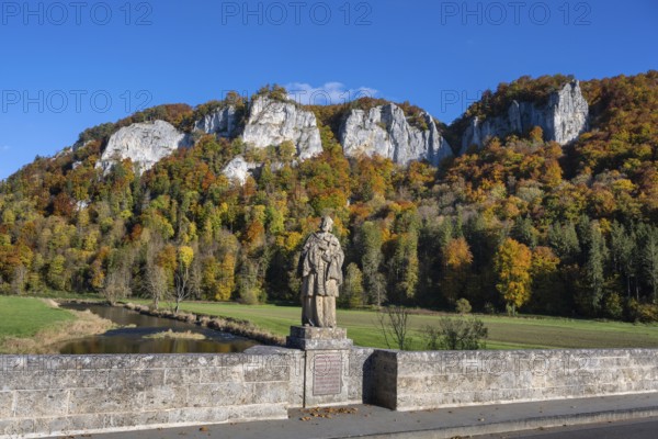 View from the historic arched bridge, Hausener Bridge across the Danube with the statue of Saint