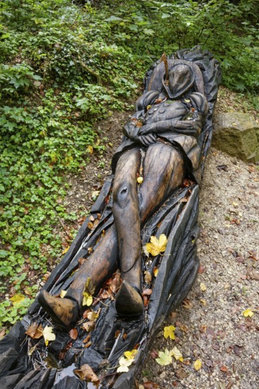 Wooden sculpture The Sleeping Count, Pfullinger Sagenweg, stories and legends, by woodsaw artist