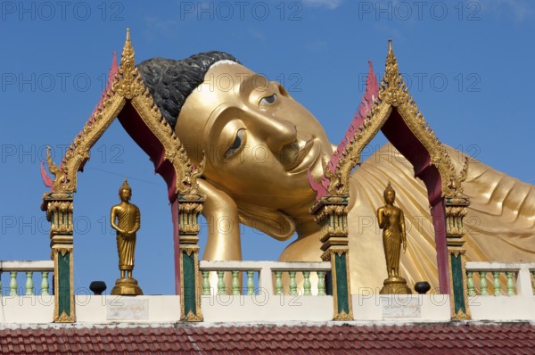 Head of reclining Buddha resting head on hand forearm on elbow, landmark of Wat Sri Sunthon