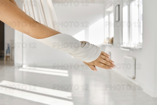 In a spacious room filled with natural light, a person engages in fitness stretching using a
