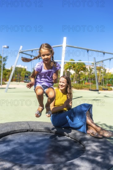 Mother and daughter experiencing a joyful moment together, with the young girl enthusiastically