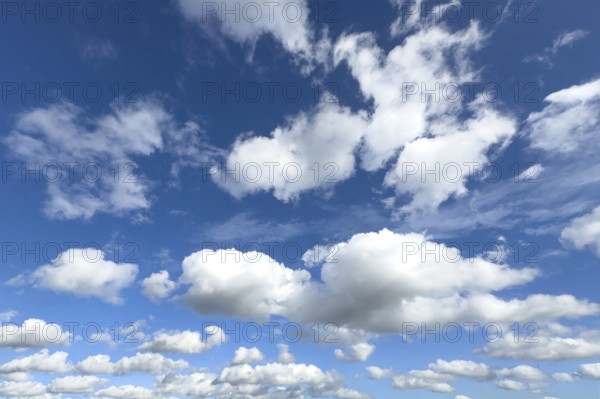 White clouds in the middle and below Cumulus above Stratocumulus loose cloudiness cloudy against