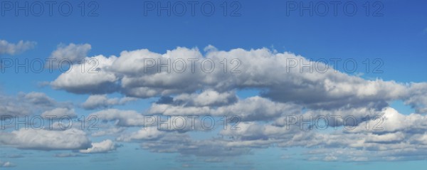 White clouds above Altocumulus in the background below Cumulus cloudy against blue cloudy sky,
