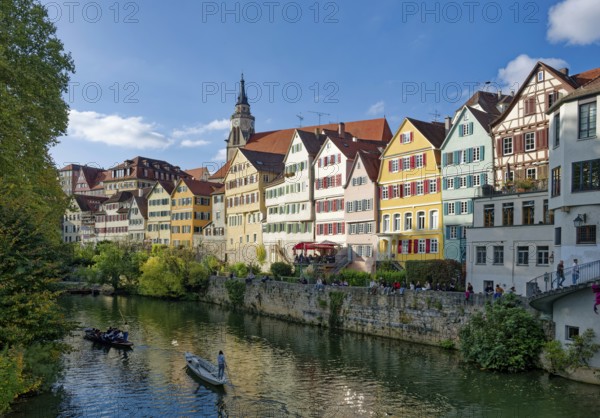 Historic houses on the Neckar front, the Neckar river with poking and water reflection, old town of