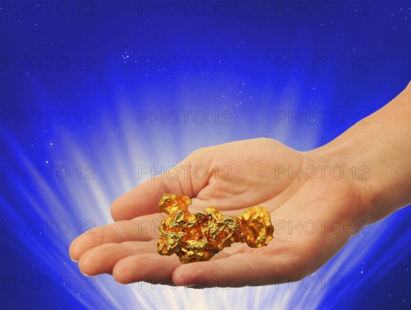 Symbolic photo, hand with gold nugget, stable value, risks, crash or upswing, financial economy,