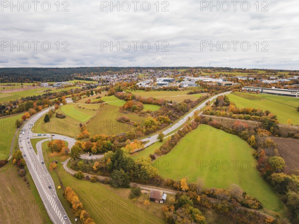 Wide landscape with winding roads, meadows and autumn atmosphere under cloudy sky, Dornstetten,