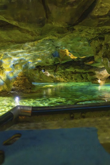 Underground scenario in a cave with shimmering green water and dramatic lighting, Wimsener Höhle,