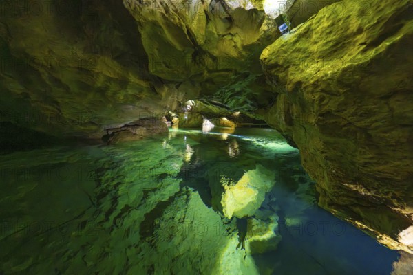 Enchanting cave with glowing water and natural rock structures in the underground, Wimsener Höhle,
