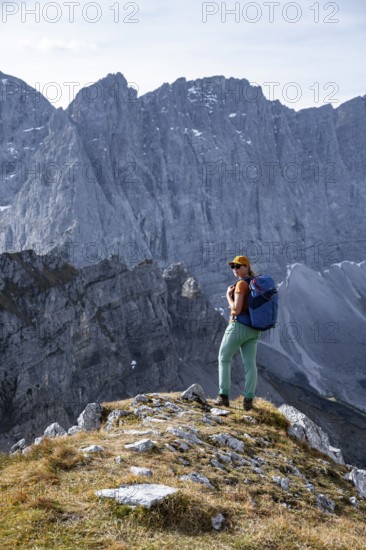Female hiker on hiking trail, hiking to Gamsjoch, behind Dreizinkenspitze and Laliederer Wand,