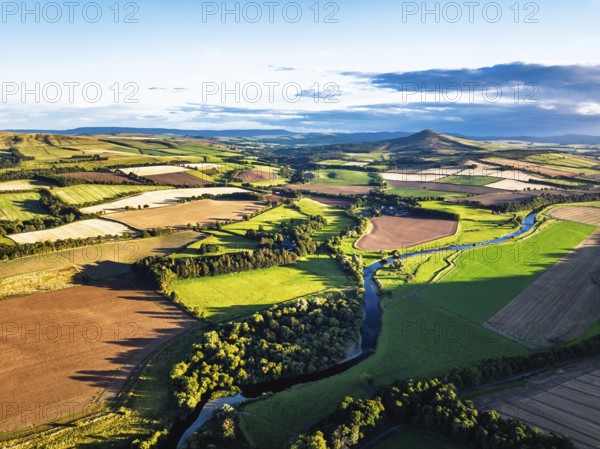 Fields and Farms over River Teviot and Minto Crags from a drone, Roxburghshire, Scottish Borders,