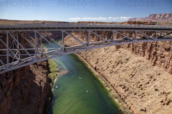 Marble Canyon, Arizona - Dories float under the Navajo Bridge which spans the Colorado River in