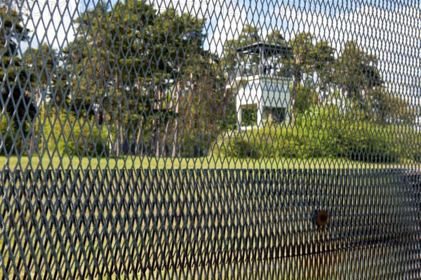 View of former area of the GDR through original GDR border fence from 1970s with death strips on