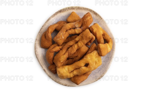 Crunchy biscuit Brushwood cookies sprinkled with powdered sugar isolated on white background, top